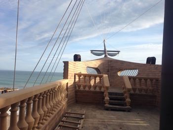 Lifeguard hut by sea against sky