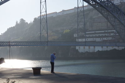 Full length of woman standing by railing