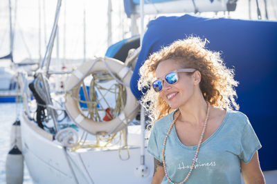 Woman wearing sunglasses standing at harbor