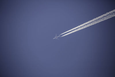 Low angle view of airplane flying in sky