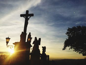 Low angle view of silhouette statue against sky during sunset