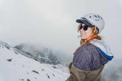 Side view of woman standing on mountain