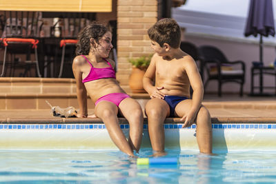 Two kids playing in a swimming pool
