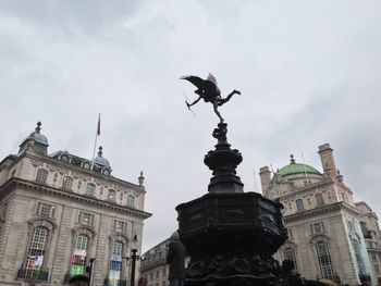 Low angle view of statue against cloudy sky