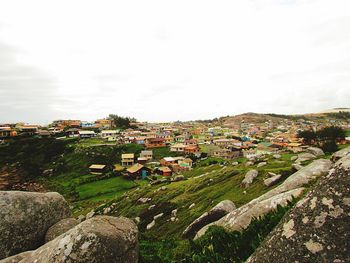 Houses on landscape against sky