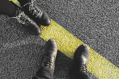 Low section of man standing on road