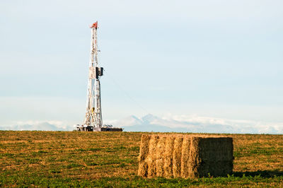 Windmill on field against sky