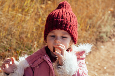 A child in nature studies the environment. holds an acorn or a nut in his hands. outdoor activities