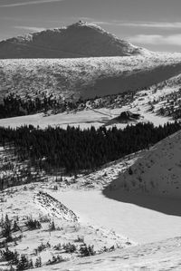 Scenic view of snow covered mountains against sky