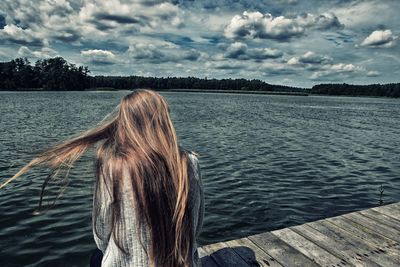 Rear view of woman looking at lake