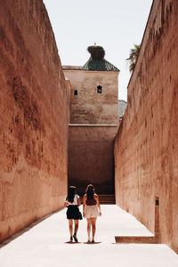 Rear view of women walking on street