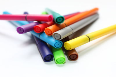 Close-up of colored pencils against white background