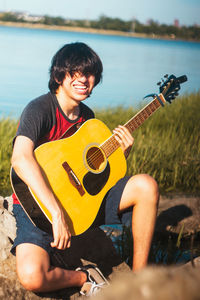 Full length of man playing guitar