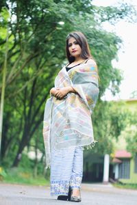 Full length of woman standing against plants