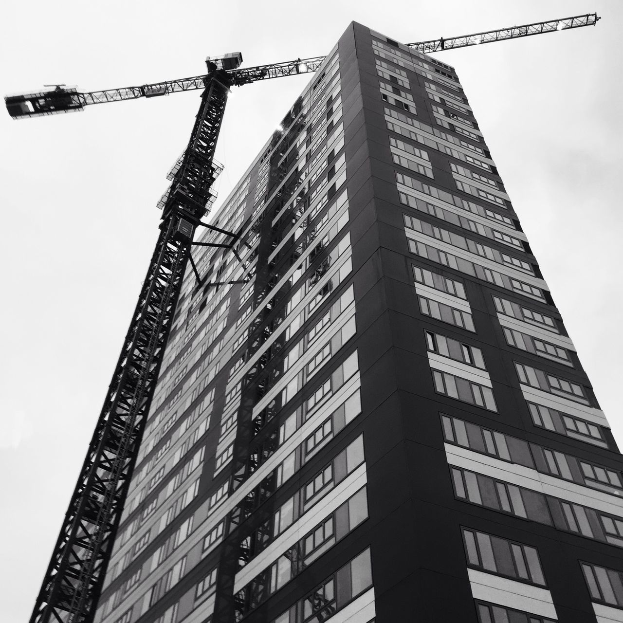 low angle view, building exterior, architecture, built structure, tall - high, tower, city, development, skyscraper, sky, clear sky, office building, crane - construction machinery, building, construction site, tall, modern, construction, outdoors, no people