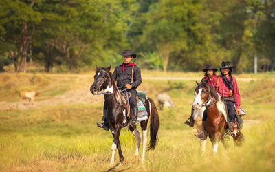 Cowboy's way of life include riding a horse around locales.