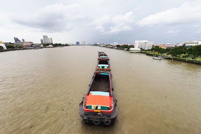 Ship in sea against sky in city