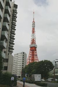 Low angle view of skyscrapers against cloudy sky