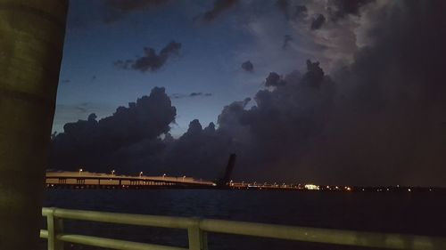 Illuminated built structure against sky at night