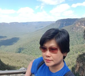 Boy on landscape against sky