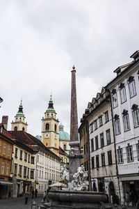 Low angle view of buildings in city against sky