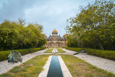 View of garden against cloudy sky