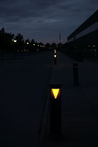 Illuminated lamp against sky at night