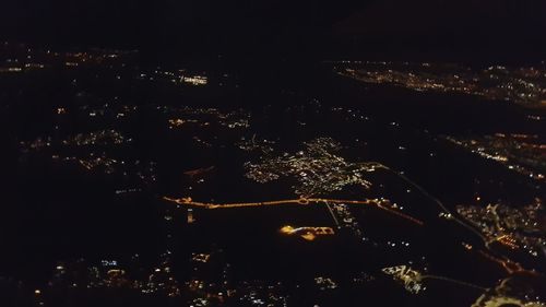 High angle view of illuminated buildings in city at night