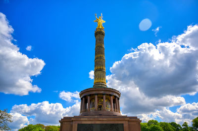 Low angle view of statue against blue sky