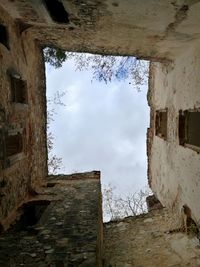 View of old building against cloudy sky