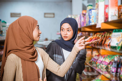 Portrait of young woman standing in store