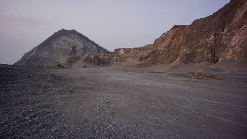 Scenic view of arid landscape against sky