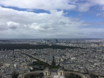 High angle view of cityscape against cloudy sky