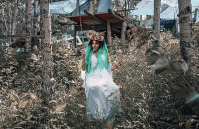 Full length of young woman standing on field