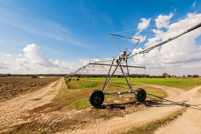 Windmill on field against sky