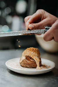 Vertical view of the unknown chief hand decorating cake at the restaurant