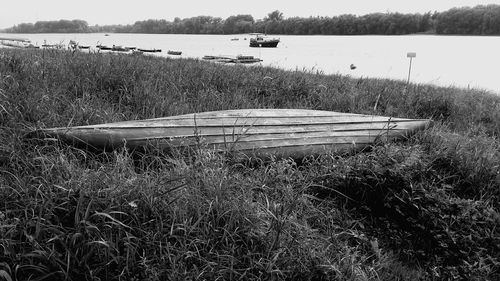 Boat moored in lake against sky