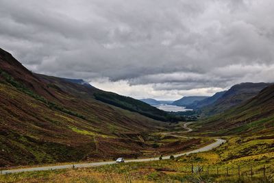 Scenic view of mountains against cloudy sky