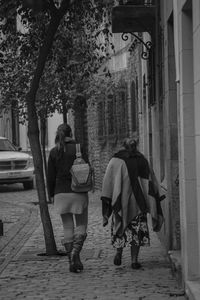 Rear view of women on tree in city