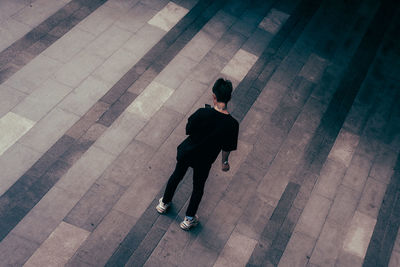 Rear view of man and woman walking on floor