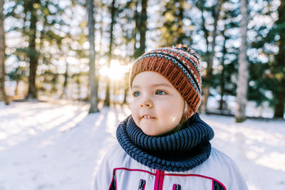 Portrait of smiling boy standing on snow