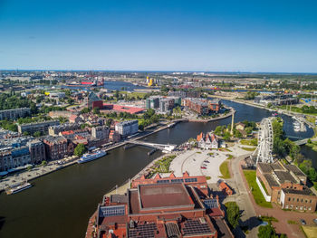 High angle view of river amidst buildings in town against sky