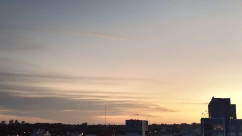 Silhouette buildings against sky during sunset