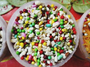 High angle view of multi colored candies in bowl on table