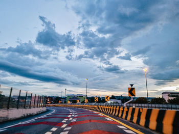 A curve on a highway with intense twilight cloud sky