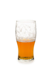 Close-up of beer glass against white background