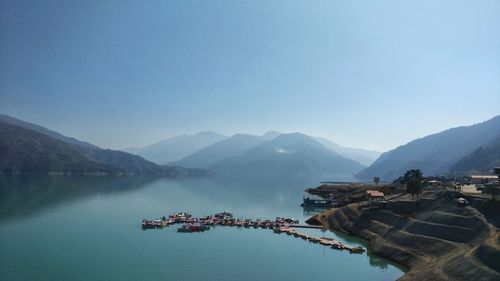 Scenic view of lake and mountains against clear sky