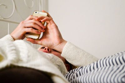 Young woman using mobile phone at home