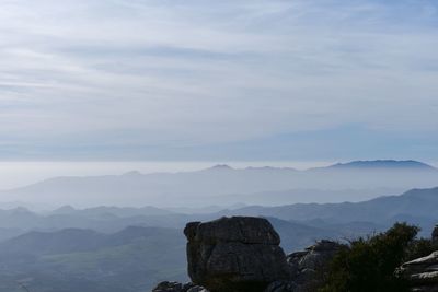 Scenic view of mountains against cloudy sky