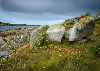 View of rocks on land against sky